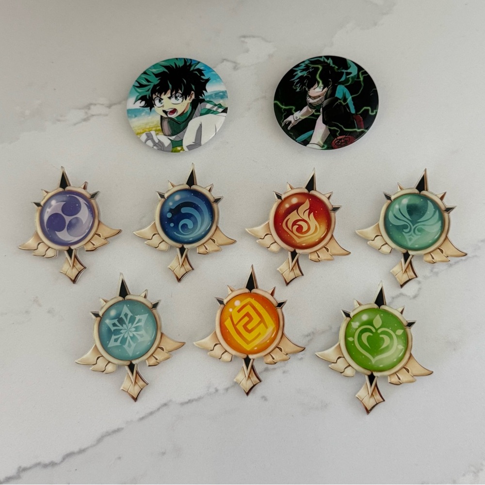 Cosplay Collectibles. 2 Tin Badge Buttons Deku and 7 Genshin Impact brooches